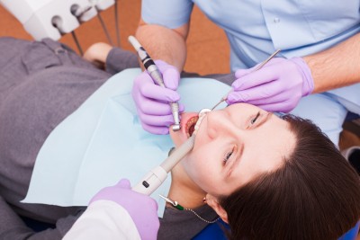 Dentist treats teeth with the help of dental instruments
